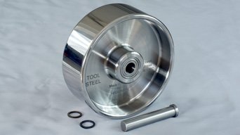 Shiny, steel top roller for english wheel. Engraving "TOOL STEEL" visible on the side